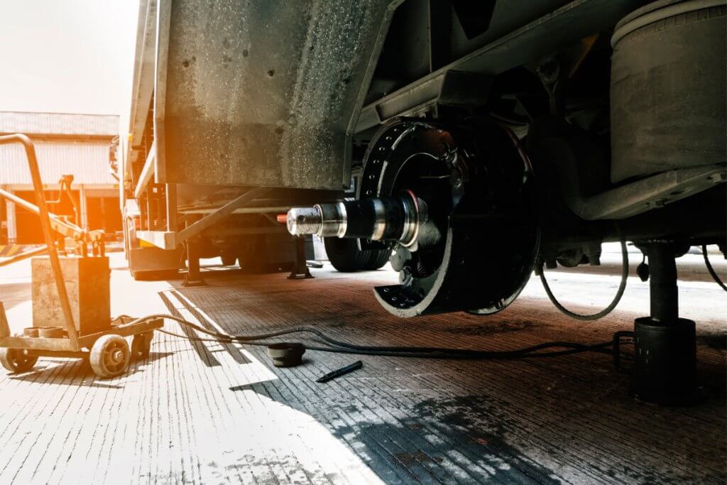Fleet manager inspecting commercial truck tire pressure to prevent FMCSA vehicle inspection violations