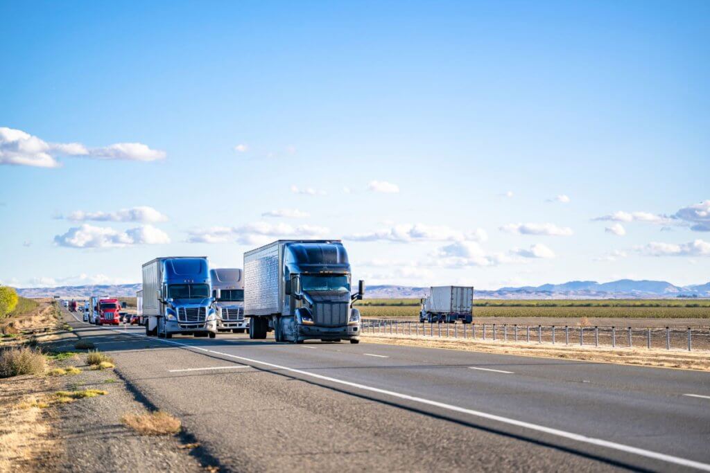 Semi trucks traveling on California highway requiring California Motor Carrier Permit for legal operation