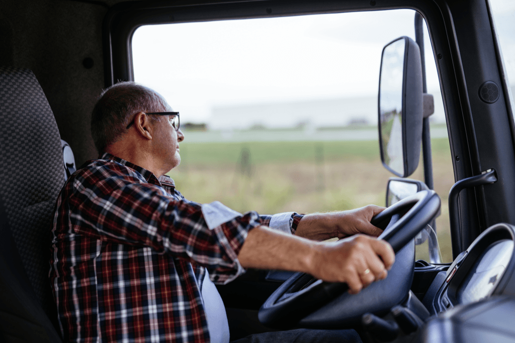 Commercial truck driver behind the wheel of a semi-truck representing ELD hours of service compliance and driver accountability requirements ahead of CVSA Roadcheck 2026.